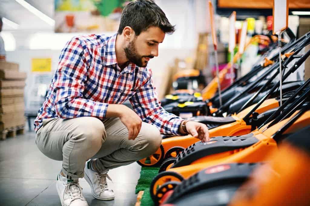 Man shopping lawn mowers