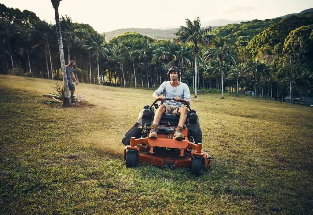 happy landscaper on a zero turn mower