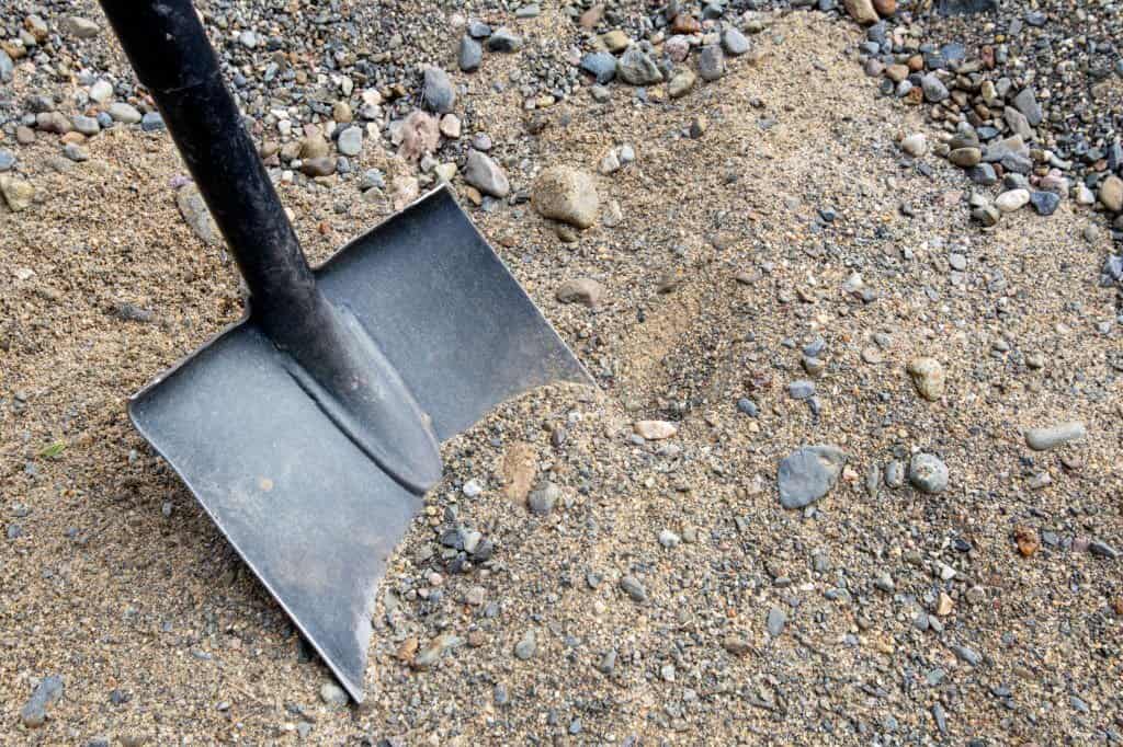 Shovel placed on sand 